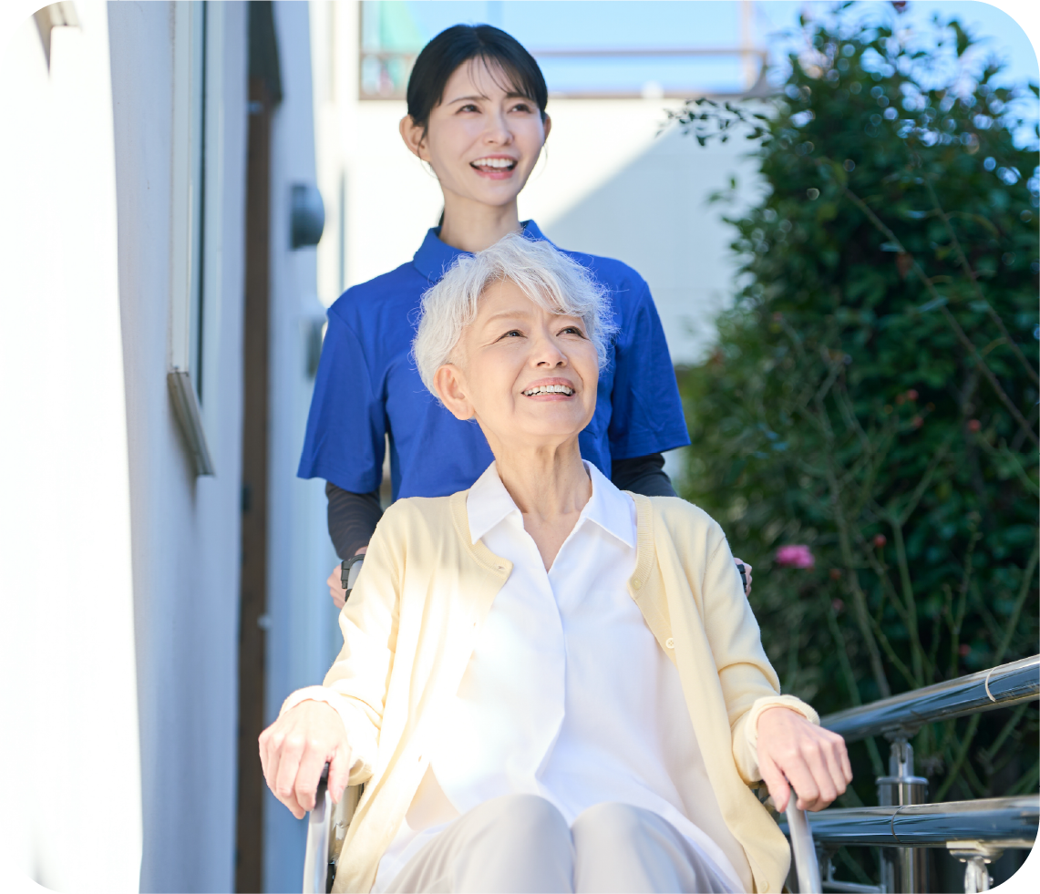 車椅子での通院を介助するスタッフ